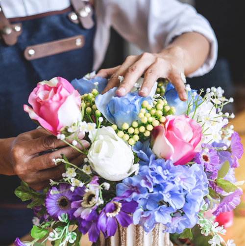 Woman arranging flowers in a vase