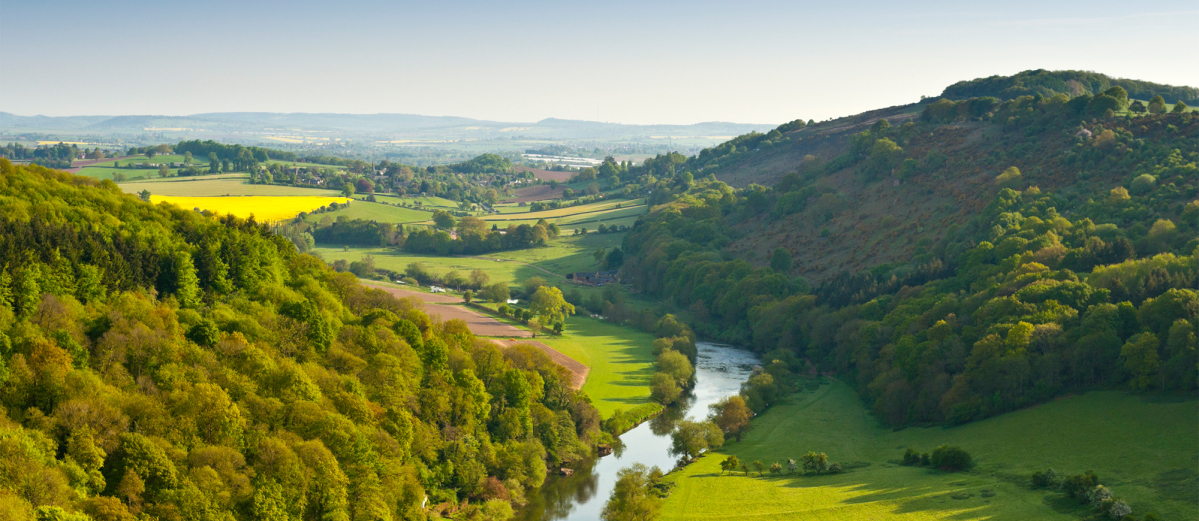 Photo of a river winding through the green British countryside