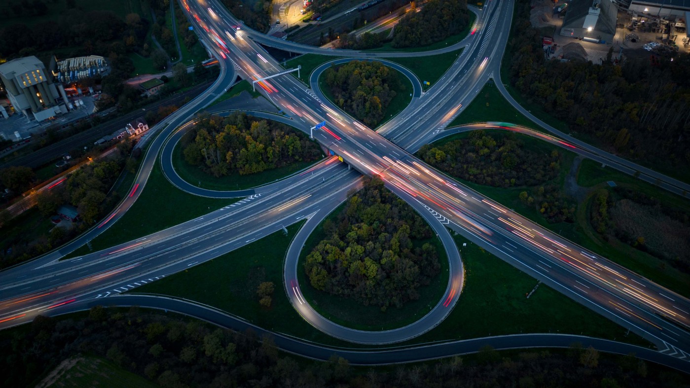 Highway interchange and industrial district at dusk - aerial view